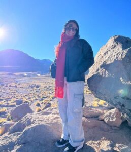 Carmen Raya in Chile, in front of a snowy, rocky landscape