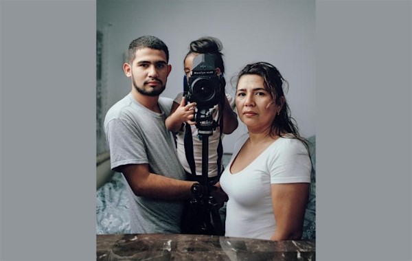 Couple with a child behind a camera